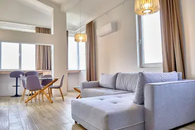 a living room with a couch and a table at Apartments Magic box II in Utjeha