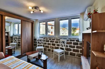 a living room with a brick wall at Basilica Apartments in Budva