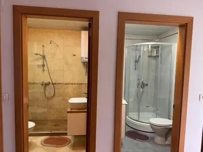 a bathroom with a shower and a sink and a toilet at Beachfront First Line View in Sveti Stefan