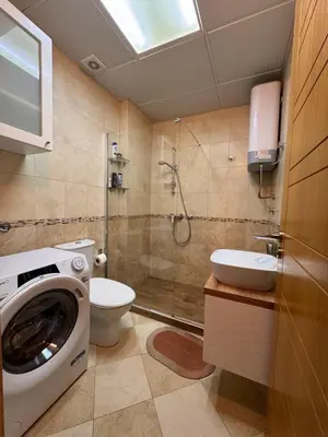 a bathroom with a washing machine and a toilet at Beachfront First Line View in Sveti Stefan