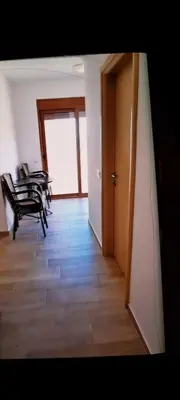 a room with a table and chairs and a door at Apartments Md Lux in Sutomore