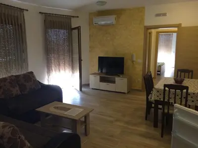 a living room with a couch and a tv at Apartments Md Lux in Sutomore