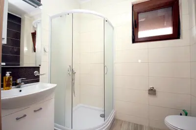 a bathroom with a shower and a sink at Apartments Md Lux in Sutomore
