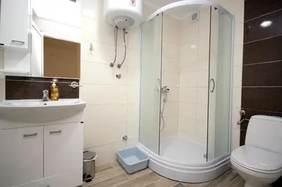 a bathroom with a shower and a toilet and a sink at Apartments Md Lux in Sutomore
