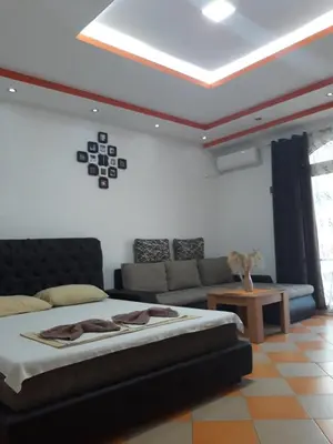 a living room with a bed and a couch at Apartments Aza in Dobra Voda