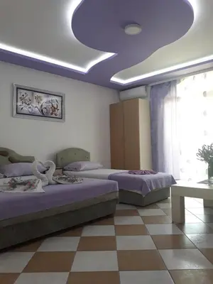 a bedroom with two beds and a blue ceiling at Apartments Aza in Dobra Voda