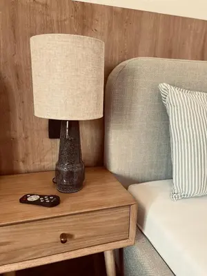 a lamp on a table next to a bed at Apartments Mrdak in Bar