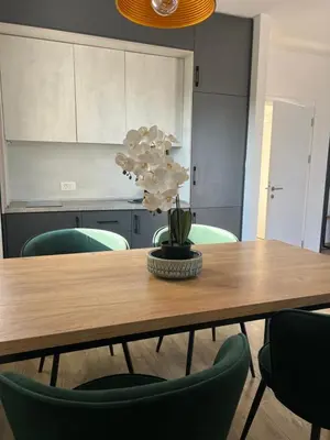 a dining room table with a potted plant on it at Apartments Mrdak in Bar