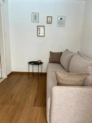 a living room with a couch and a table at Apartments Mrdak in Bar
