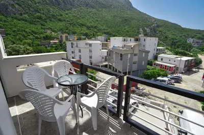 a balcony with chairs and a table with a view at Apartments A Čanj in Čanj