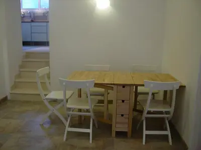 a wooden table with four chairs around it at Apartment Mimosa in Kotor
