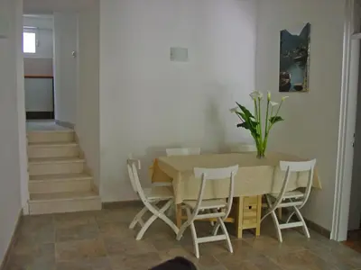 a dining room with a table and chairs at Apartment Mimosa in Kotor