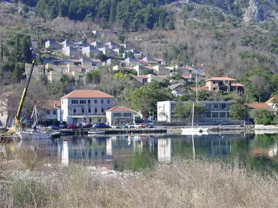 a town on a hill next to a body of water at Apartment Mimosa in Kotor