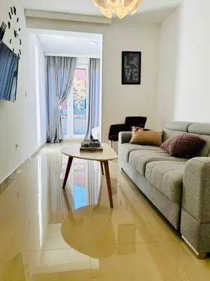 a living room with a couch and a table at Nora Apartment in Budva