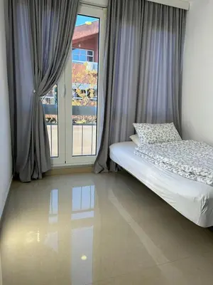 a bedroom with a bed and a large window at Nora Apartment in Budva