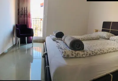 a bedroom with two beds with towels on them at Nora Apartment in Budva