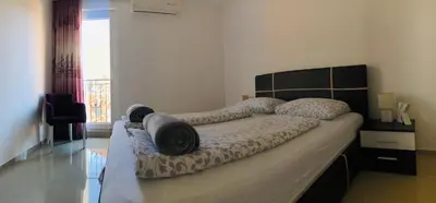 a bedroom with a large bed in a room at Nora Apartment in Budva
