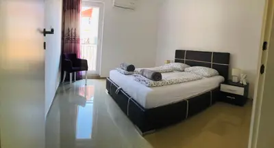 a bedroom with a bed in a room with a window at Nora Apartment in Budva