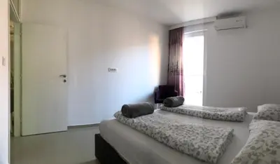 a bedroom with two beds and a window at Nora Apartment in Budva