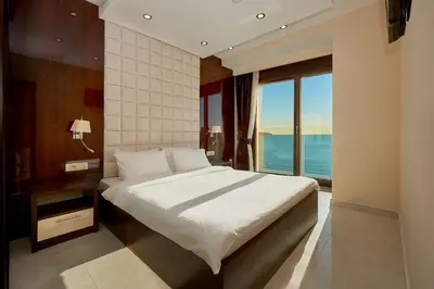 a bedroom with a bed with a view of the ocean at Shine Crystal, first line with a stunning view in Čučići