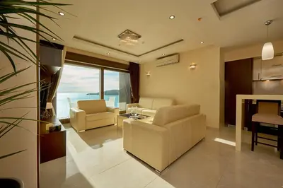 a living room with a couch and chairs and a table at Shine Crystal, first line with a stunning view in Čučići