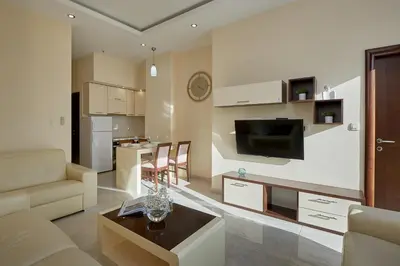 a living room with a couch and a table at Shine Crystal, first line with a stunning view in Čučići
