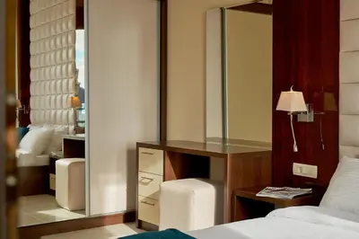 a bedroom with a mirror and a bed and a desk at Shine Crystal, first line with a stunning view in Čučići