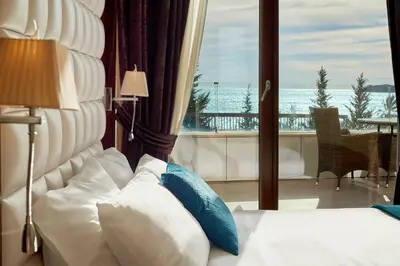 a bedroom with a bed with a view of the ocean at Shine Crystal, first line with a stunning view in Čučići