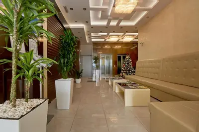 a lobby with potted plants and a christmas tree at Shine Crystal, first line with a stunning view in Čučići