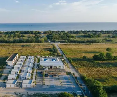an aerial view of a building with the ocean in the background at Imperial Family Resort in Ulcinj