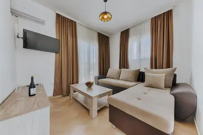 a living room with a couch and a table at Imperial Family Resort in Ulcinj