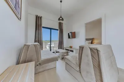 a living room with two chairs and a table at Imperial Family Resort in Ulcinj