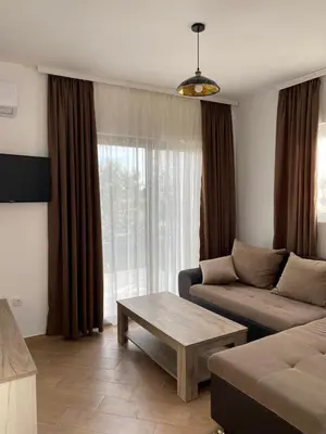 a living room with a couch and a coffee table at Imperial Family Resort in Ulcinj