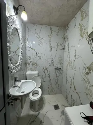 a bathroom with a toilet and a sink at Lux Apartment Oasis in Rafailovici
