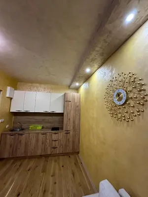 a kitchen with a clock on the wall at Lux Apartment Oasis in Rafailovici