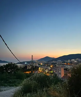 a view of a city at dusk at Lux Apartment Oasis in Rafailovici