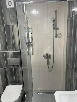 a bathroom with a shower with a toilet and a sink at Adriatic apartman in Budva