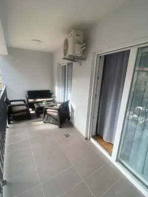 a living room with a couch and a window at Adriatic apartman in Budva