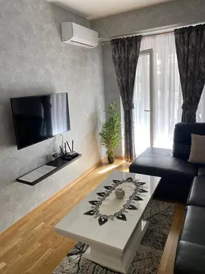 a living room with a couch and a coffee table at Adriatic apartman in Budva