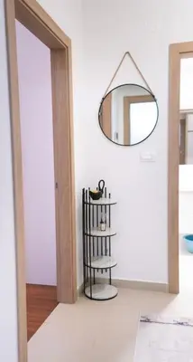 a mirror hanging on a wall in a room at Ana Lux Master apartament in Podgorica