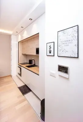 a white kitchen with a sink and a counter at Comfort apartment Becici by In Property in Becici