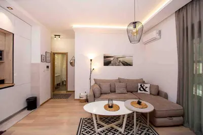 a living room with a couch and a table at Comfort apartment Becici by In Property in Becici