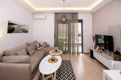 a living room with a couch and a table at Comfort apartment Becici by In Property in Becici