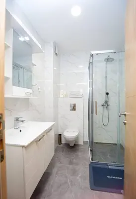 a bathroom with a shower and a toilet and a sink at Comfort apartment Becici by In Property in Becici
