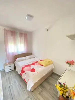 a bedroom with a bed with red hearts on it at OLGA APARTMENT in Kotor