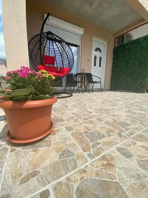 a patio with a potted plant and a hanging basket at OLGA APARTMENT in Kotor