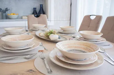 a table with bowls and plates and silverware on it at The Dream Getaway SkyLine by DeVasco in Becici