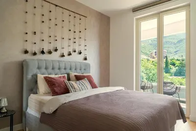 a bedroom with a bed and a large window at The Dream Getaway SkyLine by DeVasco in Becici