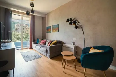 a living room with a couch and a table at The Dream Getaway SkyLine by DeVasco in Becici