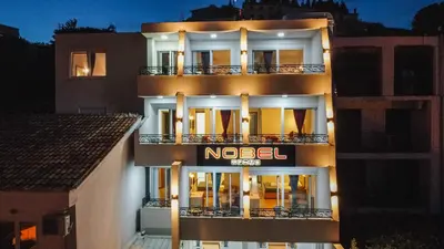 a hotel with a nel sign on the side of a building at Hotel NOBEL Ulcinj in Ulcinj